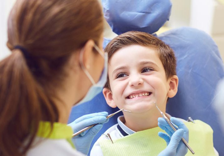 A child with a dentist in a dental office. A child with a dentist in a dental office. Dental treatment in a children's clinic.